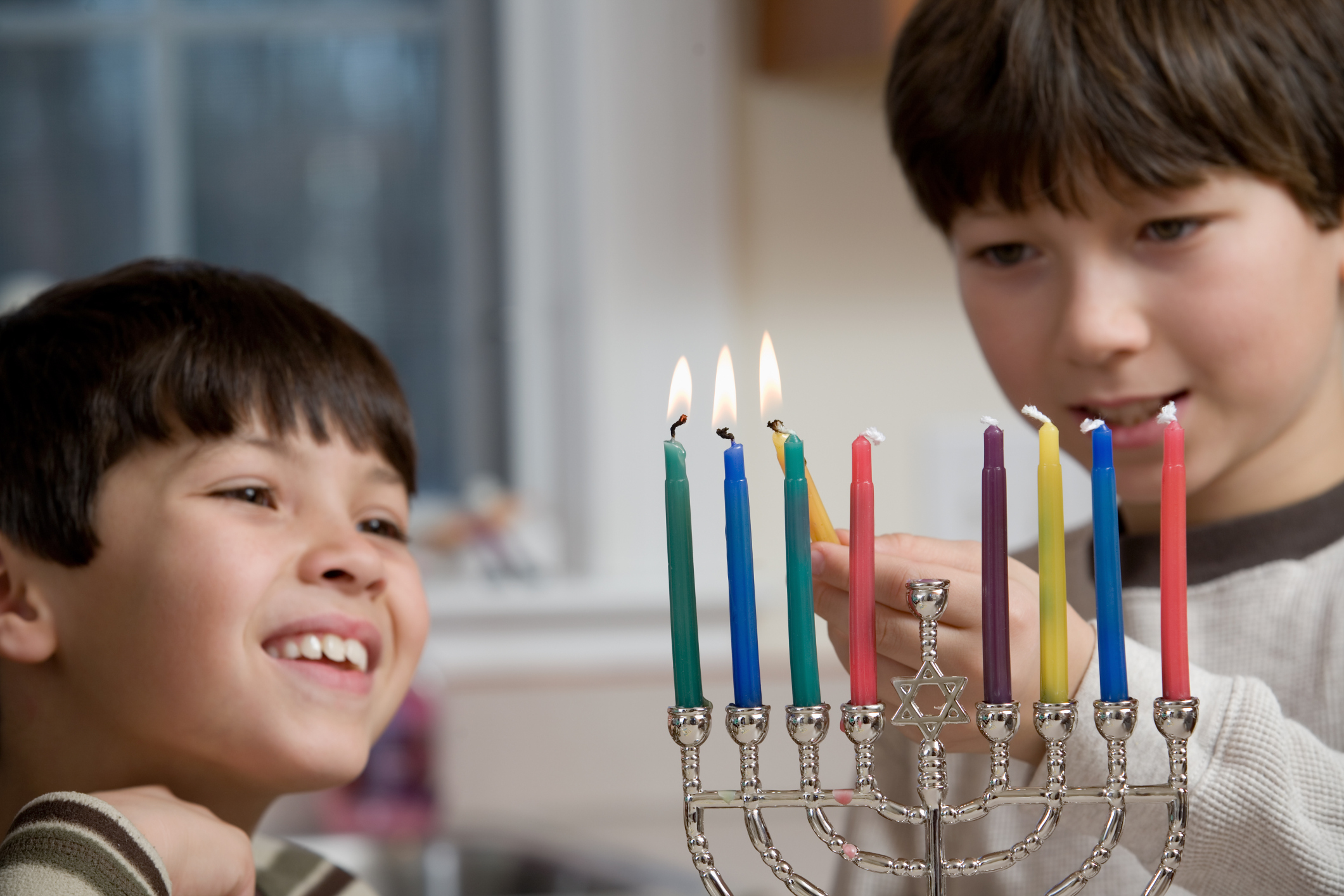 Boys Lighting The Menorah