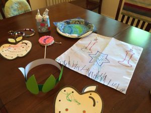 Crafts: apples on a string, toilet-paper roll Torah, seder plate, challah cover, crown of leaves, gregor. 
