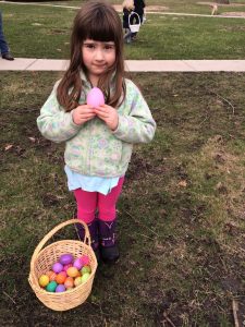 My daughter shows off her Easter egg hunt success. 